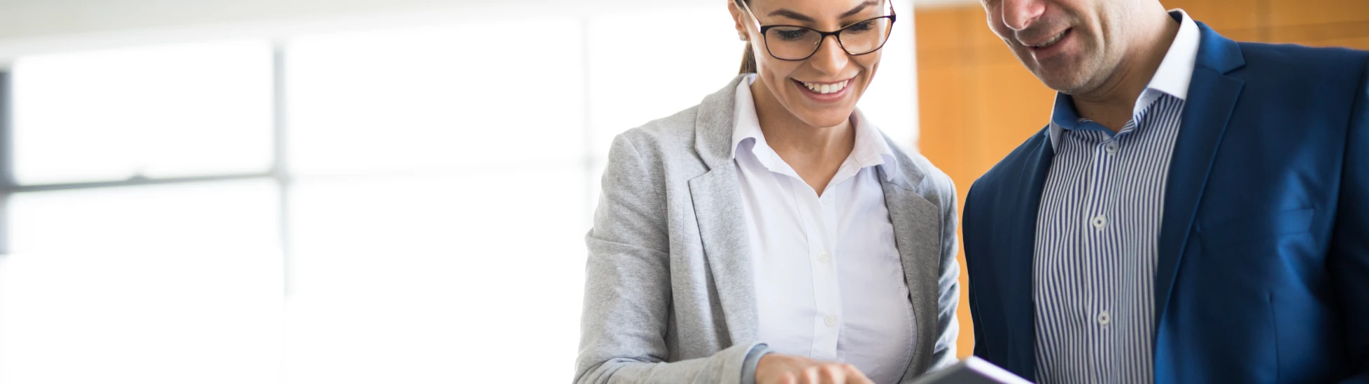 Two business people discussing business strategy using a tablet