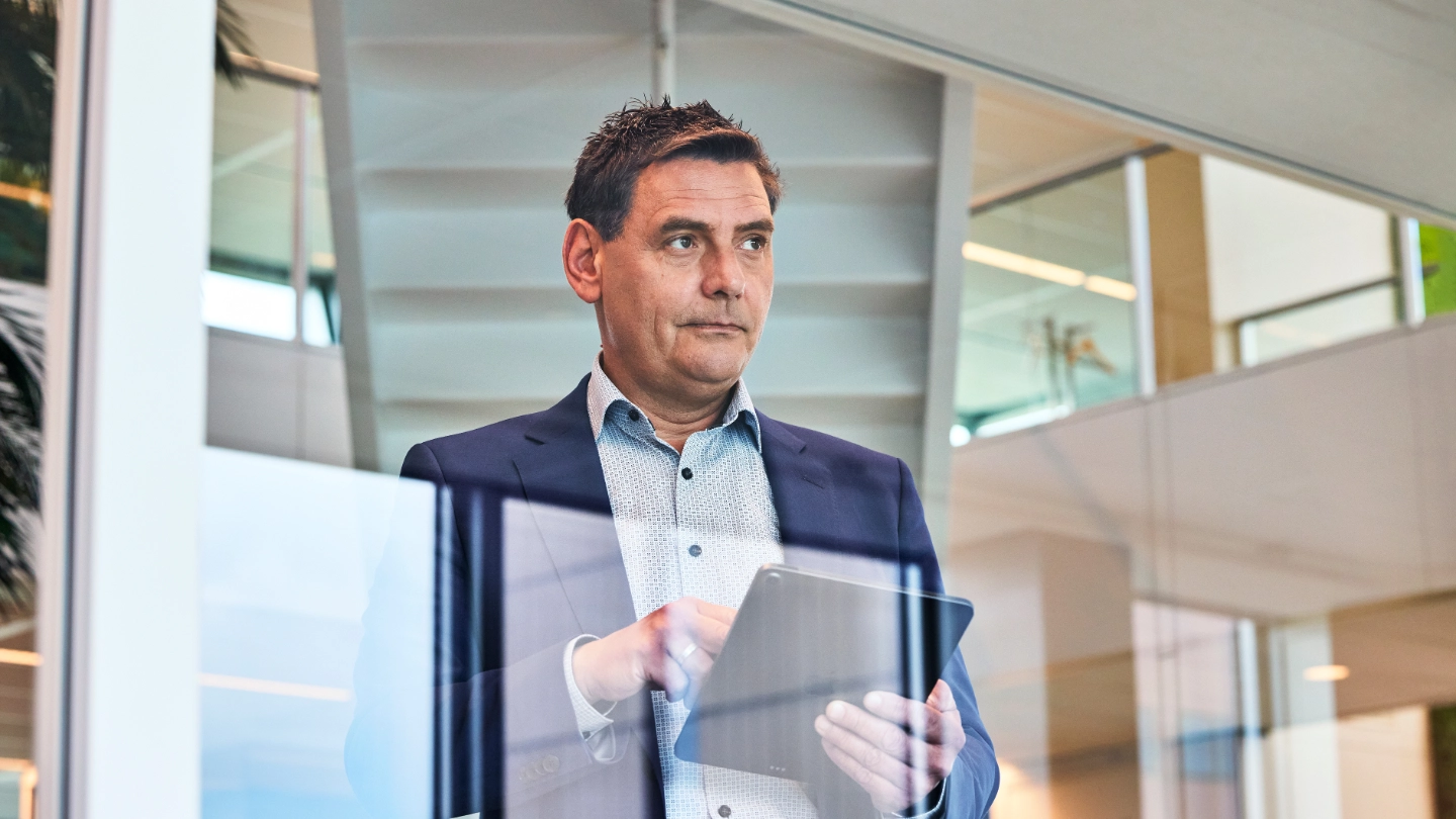 Atradius worker reflects on the news he read on his tablet Atradius worker reflects on the news he read on his tablet