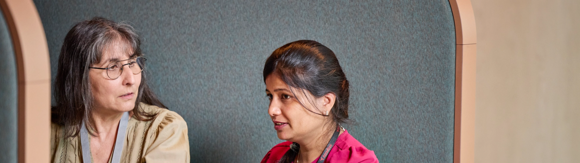 Two Atradius colleagues working in a breakout area