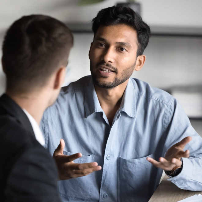 man talking with another man using hands