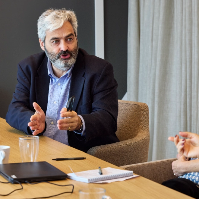 Senior man is explaining at a workshop
